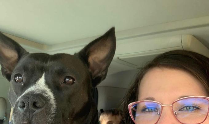 Ruby Fooks beside a dog in a vehicle